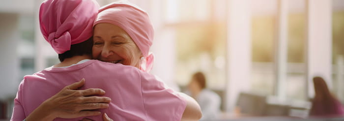 Cancer patients embrace medical staff after treatment